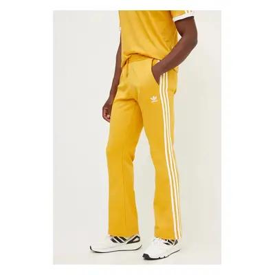 Tepláky adidas Originals 70S Track Pant žlutá barva, s aplikací, IX5223