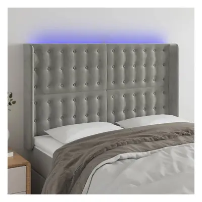 Čelo postele s LED světle šedé 147x16x118/128 cm samet