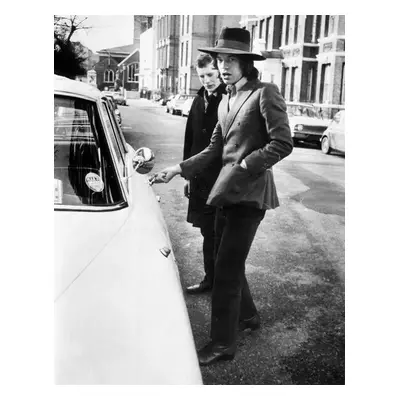 Fotografie Jagger, singer with the Rolling Stones, about to get into his car, c.1970