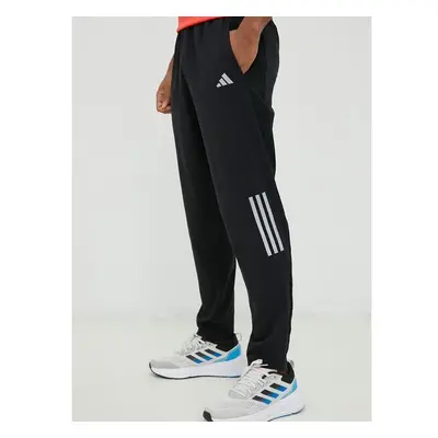 Běžecké kalhoty adidas Performance Own the Run černá barva, potiskem 75826924